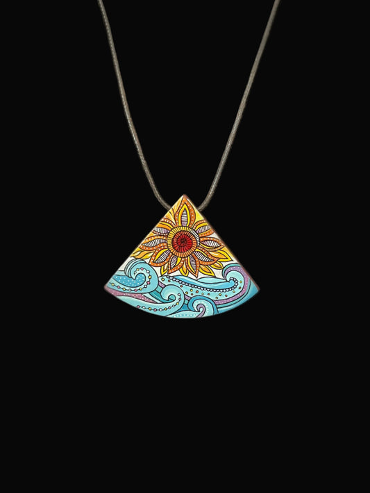 Colorful triangular pendant with floral design 